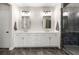 Bathroom with double vanity, white cabinets, and a modern glass-enclosed shower with dark tile at 714 Opera Ln, Alpharetta, GA 30009