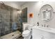 Bathroom featuring tiled shower with glass door, modern vanity with white countertop, and round mirror at 714 Opera Ln, Alpharetta, GA 30009