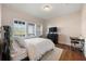 Bedroom with wood floors, a large window with shutters, and a black desk at 714 Opera Ln, Alpharetta, GA 30009