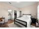 Bedroom with wood floors, closet, en-suite bathroom, simple black bed frame and white comforter at 714 Opera Ln, Alpharetta, GA 30009