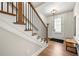 Entryway with hardwood floors, wood and iron staircase, and a paneled glass door at 714 Opera Ln, Alpharetta, GA 30009