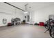 Spacious two-car garage with a clean epoxy floor and plenty of storage space and mounted EV charger at 714 Opera Ln, Alpharetta, GA 30009