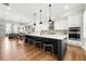 Open kitchen features a large island with seating, pendant lighting, and modern appliances at 714 Opera Ln, Alpharetta, GA 30009