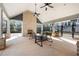Picturesque outdoor fireplace with ample seating and ceiling fans for perfect outdoor relaxation at 714 Opera Ln, Alpharetta, GA 30009