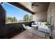 Relaxing covered patio featuring neutral outdoor seating and string lights with a beautiful view of trees at 714 Opera Ln, Alpharetta, GA 30009