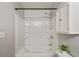 Bright bathroom featuring a shower-tub combination with tiled walls and modern fixtures at 1096 Liberty Nw Pkwy, Atlanta, GA 30318