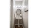 Powder room featuring a pedestal sink, oval mirror, and soft lighting, complemented by stylish flooring at 1096 Liberty Nw Pkwy, Atlanta, GA 30318