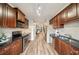 Modern kitchen with stainless steel appliances and dark cabinetry flowing into dining and living spaces at 1096 Liberty Nw Pkwy, Atlanta, GA 30318