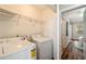 Cozy laundry area featuring a washer, dryer, and shelving for efficient organization at 1096 Liberty Nw Pkwy, Atlanta, GA 30318