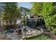 Charming backyard with a lovely stone patio and a cozy fire pit area at 1111 Seaboard Nw Ave, Atlanta, GA 30318