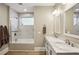 Bathroom with marble countertops, white cabinets, bathtub, and shower at 1111 Seaboard Nw Ave, Atlanta, GA 30318