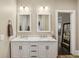 Double vanity in modern bathroom with marble countertop and white cabinetry at 1111 Seaboard Nw Ave, Atlanta, GA 30318