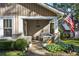 Inviting front porch with stone accents, a bench, and fresh landscaping at 1111 Seaboard Nw Ave, Atlanta, GA 30318