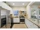 Well-lit kitchen with granite countertops and stainless steel appliances at 1111 Seaboard Nw Ave, Atlanta, GA 30318