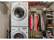 Laundry room with stackable washer and dryer and closet for storing clothes at 1111 Seaboard Nw Ave, Atlanta, GA 30318