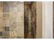 Shower with mosaic tile flooring and stone tile walls at 1111 Seaboard Nw Ave, Atlanta, GA 30318