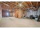Spacious unfinished basement ready for customization with exposed beams and concrete flooring at 231 Beechwood Ln, Stone Mountain, GA 30087