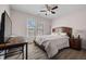 Well-lit bedroom with hardwood floors, ceiling fan and two windows at 231 Beechwood Ln, Stone Mountain, GA 30087