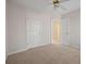 Carpeted bedroom with standard closet and two doors at 231 Beechwood Ln, Stone Mountain, GA 30087