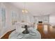 Open dining area with chandelier, marble table, and lots of natural light and fireplace view at 231 Beechwood Ln, Stone Mountain, GA 30087