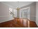 Dining room featuring hardwood floors, chandelier, and view to the front door at 231 Beechwood Ln, Stone Mountain, GA 30087