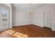 Dining room featuring hardwood floors, chandelier, and large bay window at 231 Beechwood Ln, Stone Mountain, GA 30087