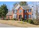 Charming two-story brick home with black shutters and manicured landscaping at 231 Beechwood Ln, Stone Mountain, GA 30087
