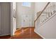 Bright foyer with hardwood floors, staircase, and decorated front door at 231 Beechwood Ln, Stone Mountain, GA 30087