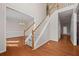 Bright foyer with hardwood floors, staircase, and view into the dining room at 231 Beechwood Ln, Stone Mountain, GA 30087