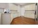 Kitchen features white cabinets, stainless steel appliances, and hardwood floors at 231 Beechwood Ln, Stone Mountain, GA 30087
