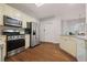 Modern kitchen appliances, gas range and refrigerator and bright white cabinets at 231 Beechwood Ln, Stone Mountain, GA 30087