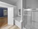 Bathroom featuring a soaking tub, glass shower, tile flooring, and large window at 1446 Dunton Green Way, Lawrenceville, GA 30043