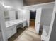 Bathroom with double sinks, wood-look flooring, a large mirror, and natural light at 1446 Dunton Green Way, Lawrenceville, GA 30043