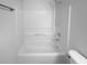 Bathroom featuring shower-tub combination with white fixtures and shower caddy at 1446 Dunton Green Way, Lawrenceville, GA 30043