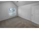 Bedroom with neutral walls and carpet, large window with blinds, and a vaulted ceiling at 1446 Dunton Green Way, Lawrenceville, GA 30043
