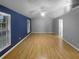 Bedroom featuring vaulted ceilings, large windows, hardwood floors, and gray and blue paint at 1446 Dunton Green Way, Lawrenceville, GA 30043