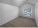 Bedroom with neutral walls and carpet, large window with blinds, and a vaulted ceiling at 1446 Dunton Green Way, Lawrenceville, GA 30043