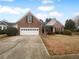 Charming brick home with a two-car garage and manicured front yard, providing a welcoming curb appeal at 1446 Dunton Green Way, Lawrenceville, GA 30043