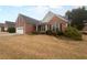 A well-maintained home exterior with a brick facade and dark shutters, offering a classic look and landscaped yard at 1446 Dunton Green Way, Lawrenceville, GA 30043