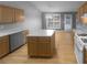 Well-lit kitchen featuring an island, modern appliances, and ample cabinet space at 1446 Dunton Green Way, Lawrenceville, GA 30043