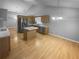 Bright, open kitchen with an island, stainless steel refrigerator, and hardwood floors at 1446 Dunton Green Way, Lawrenceville, GA 30043