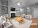 Bright living room featuring a fireplace, built-in shelves, and a comfortable seating arrangement at 1446 Dunton Green Way, Lawrenceville, GA 30043
