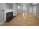 Open-concept living area with hardwood floors, a fireplace, and plenty of space for entertaining at 1446 Dunton Green Way, Lawrenceville, GA 30043