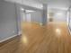 Large living area with hardwood floors, flowing into kitchen, providing plenty of natural light at 1446 Dunton Green Way, Lawrenceville, GA 30043