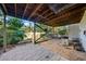 View of the backyard patio area showing brick pavers and the support structure for the deck above at 1532 Oak Grove Rd, Decatur, GA 30033