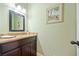 Charming bathroom featuring elegant vanity with marble top, decorative mirror, and fresh paint at 1532 Oak Grove Rd, Decatur, GA 30033