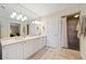 Modern bathroom with a double sink vanity, large mirror, and a tiled walk-in shower with a neutral color scheme at 1532 Oak Grove Rd, Decatur, GA 30033