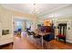 Open dining room with hardwood floors, modern chandelier, and large mirror for added ambiance at 1532 Oak Grove Rd, Decatur, GA 30033
