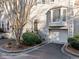 Close up on charming townhome featuring an attached garage, front yard landscaping, and neutral paint scheme at 1532 Oak Grove Rd, Decatur, GA 30033