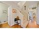 Entryway of home featuring hardwood floors, stairs, and views of a living area with fireplace at 1532 Oak Grove Rd, Decatur, GA 30033